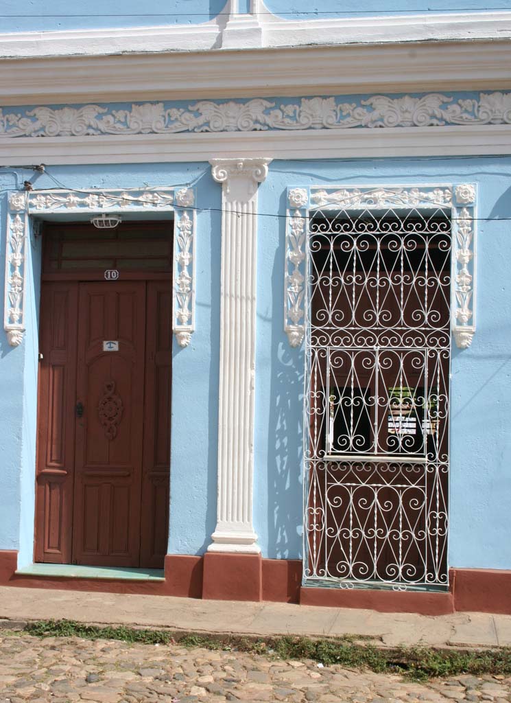 This one, with its elaborate window grille, is a <em>casa particular</em> - see the little sign on the door.