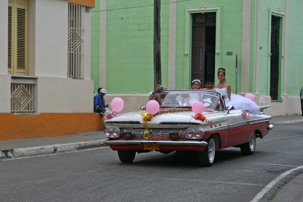 The girl standing up in the Chevy Impala in Camagüey might have been enjoying her <em>quinceañera,</em> a celebration for the coming of age on her 15th birthday.
