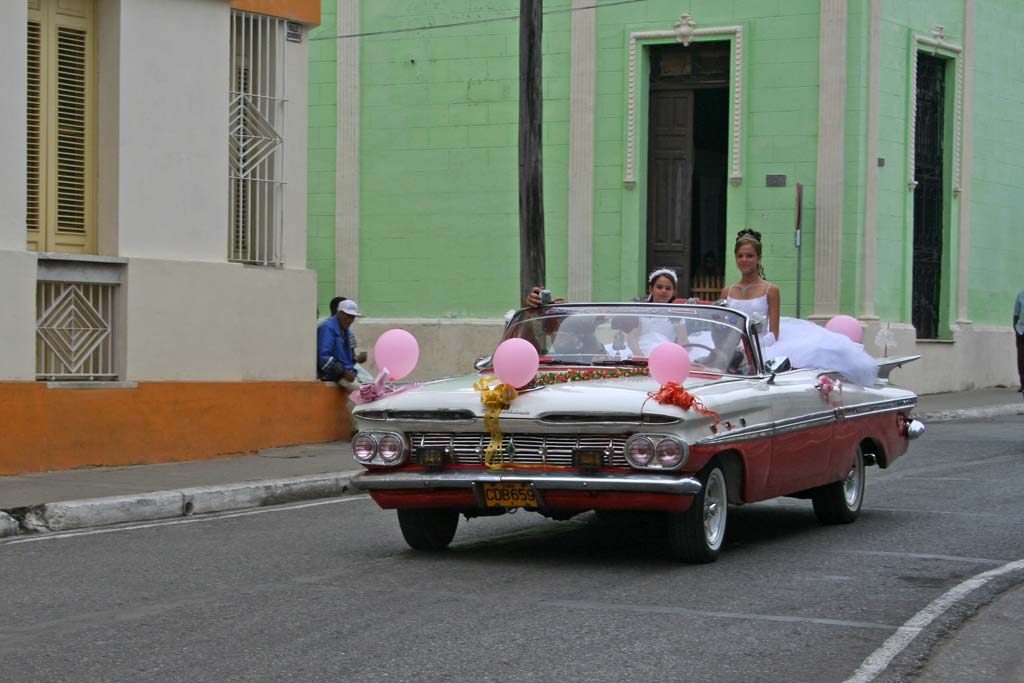 The girl standing up in the Chevy Impala might have been enjoying her <em>quinceañera,</em> a celebration for the coming of age on her 15th birthday.