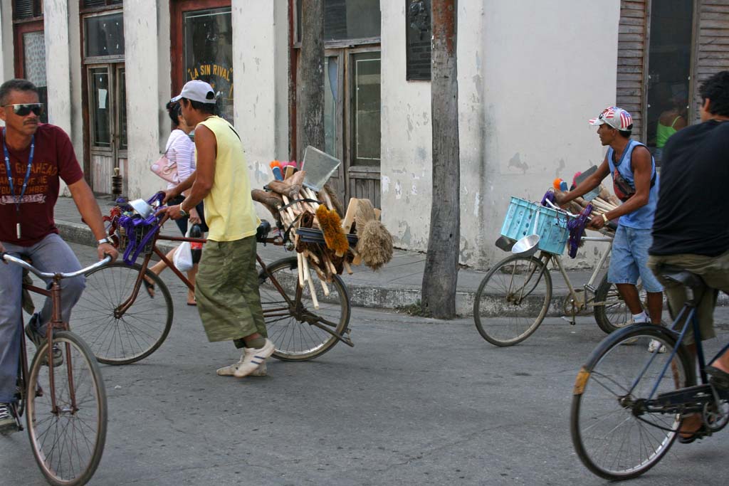 Selling brushes from bikes.