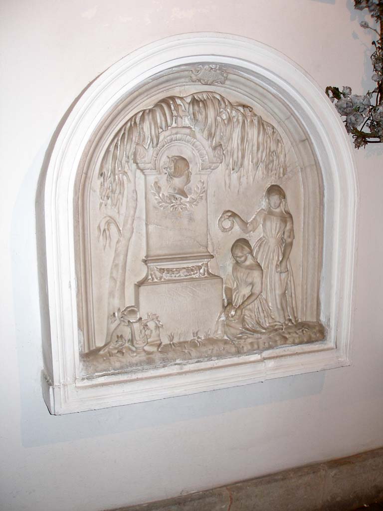 One of a collection of marble tombstones.