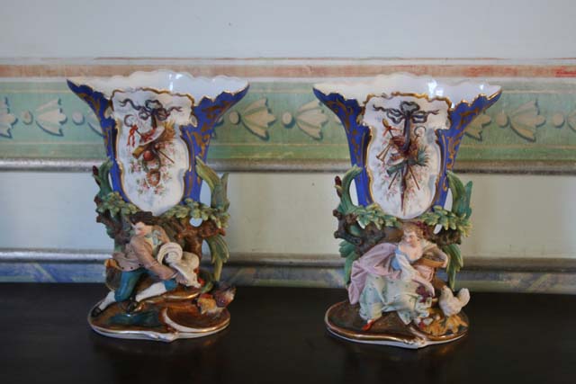 A pair of vases with rustic figures.