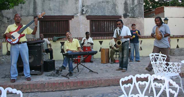 Tenor sax solo, while the trumpet player becomes a mad guiro artist.