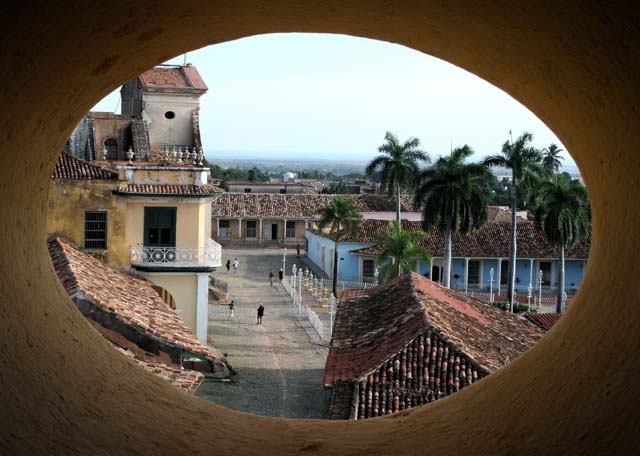 Through an oval porthole, halfway up Trinidad's <em>Museo de la Lucha Contra Bandidos</em> bell tower, towards <em>Plaza Mayor.</em>