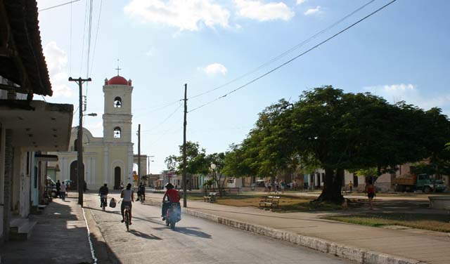 A square and church with a fine tree.
