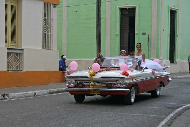 Camagüey: the girl standing up in the Chevy Impala might have been enjoying her <em>quinceañera,</em> a celebration for the coming of age on her 15th birthday.