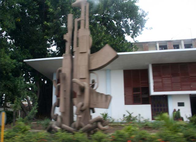 Taken from the moving bus: presumably a revolutionary monument to the AK47.