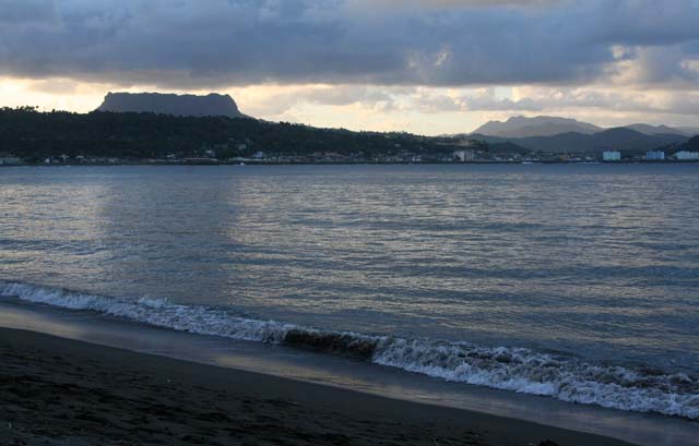 Across the bay to Baracoa at dusk, with <em>El Yunque</em> behind.