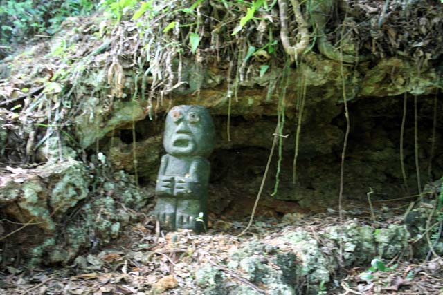 A small <em>Taíno</em>(?) statue outside.