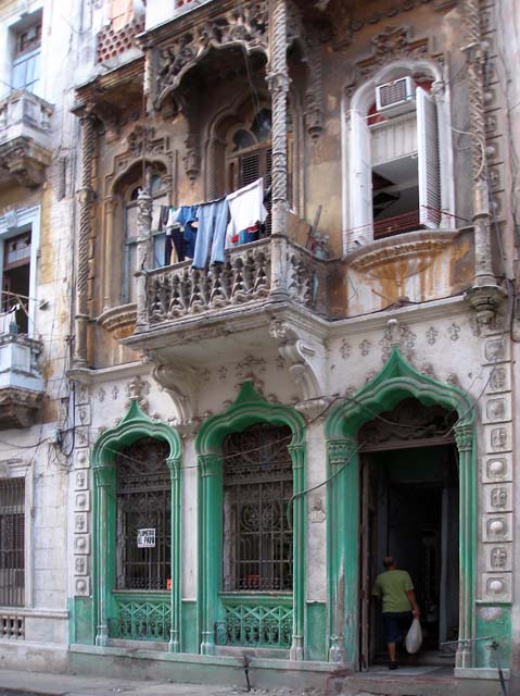 Next-door but one, the top balcony's only held up by a steel rod.