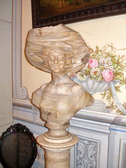 Very subtly carved marble bust of a woman with a veil.