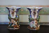 A pair of vases with rustic figures.