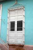 The ornate grille around the window.