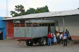 Passengers boarding a truck.