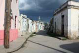 One of Camagüey's curved streets under a threatening sky.