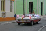 The girl standing up in the Chevy Impala in Camagüey might have been enjoying her quinceañera, a celebration for the coming of age on her 15th birthday.