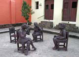 A group of women chatting. The empty chair's a nice touch.