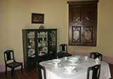 Dining table and chairs, display cabinet and built-in corner cupboard.