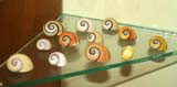 A collecion of brightly coloured polimita snail shells in the local history museum at Baracoa.