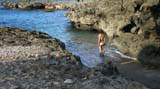 Mary taking to the water from the tiny Playa Blanca, between the rocks in the bottom right hand corner of the photo.