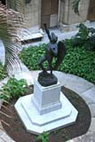 A statue in a courtyard, seen from an upstairs window.