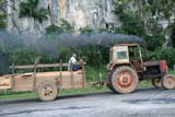 A tractor struggling up the hill and emitting the usual cloud of filth.