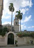 A gate, a church and a couple of royal palms.