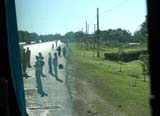 Hitch-hikers - another important form of transport in Cuba - waiting at a junction.