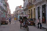 A typical street in Habana Centro, complete with bicitaxi and a Lada with its bonnet up.