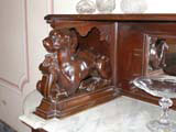 Carved dog support at one end of a marble topped sideboard...