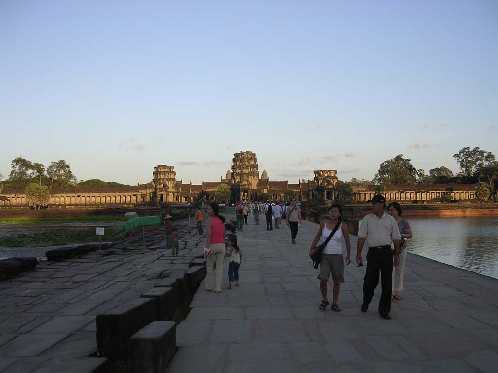 On the causeway across the moat (no, that's the gate in the distance, not the temple!)