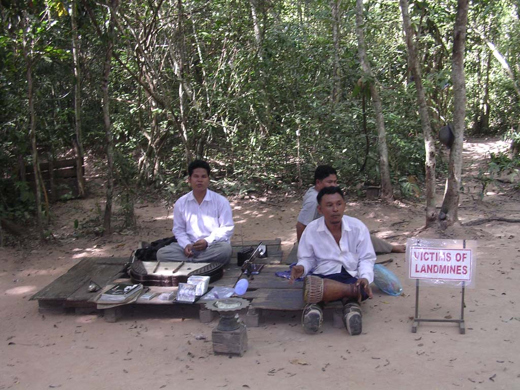 Band of land-mine victim buskers on the approach road