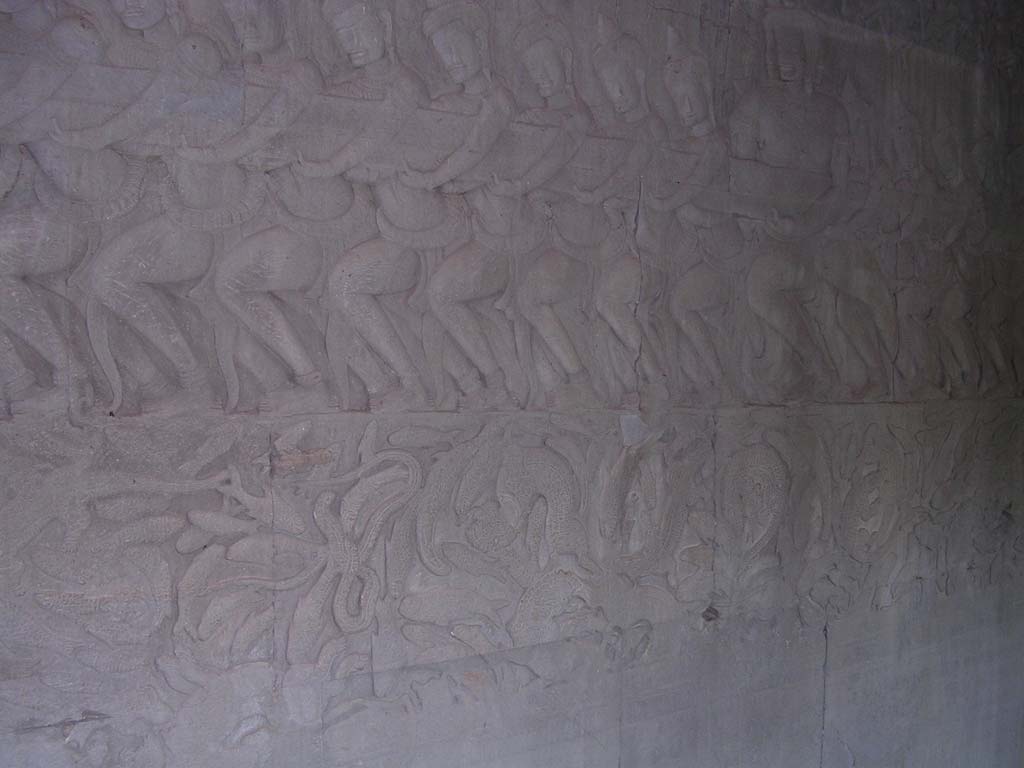 Churning of the Ocean of Milk: <em>deva</em> (gods) holding the tail half of the serpent, with fish below