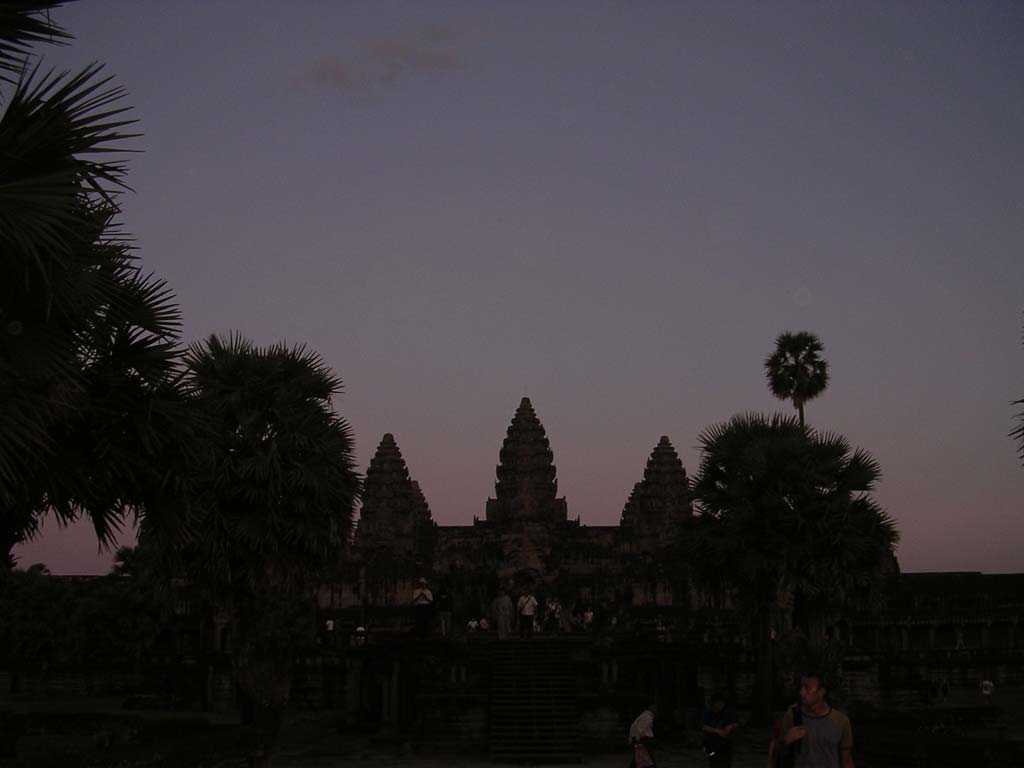Near-silhouette of the temple with sugar palms (the national tree) at dusk