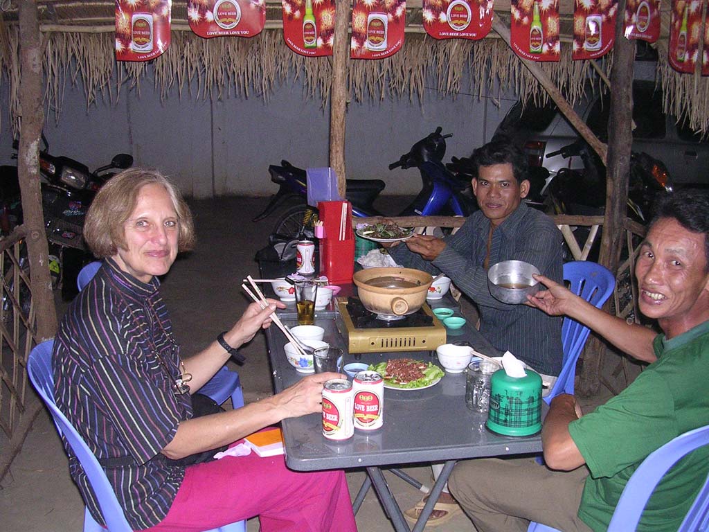 Dinner: Sambath holds up beef with red ants (the best beef we had in Cambodia!) and Han Houn 'Cambodian whisky'