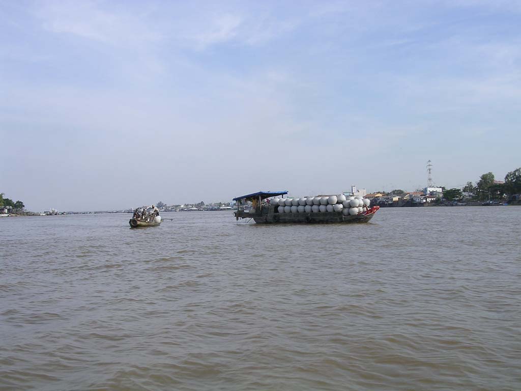 A shipment of very large pots - it looks as if the people in the small boat have just bought one.