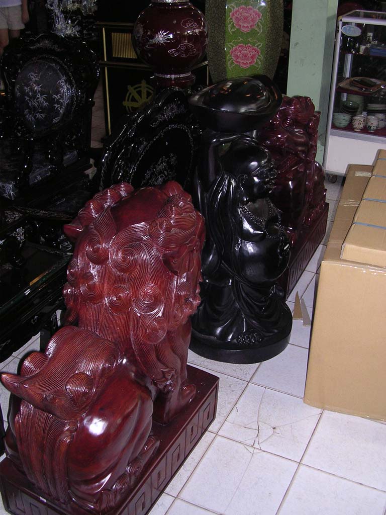 A pair of lions and a laughing Buddha (awkward shot because of the box)
