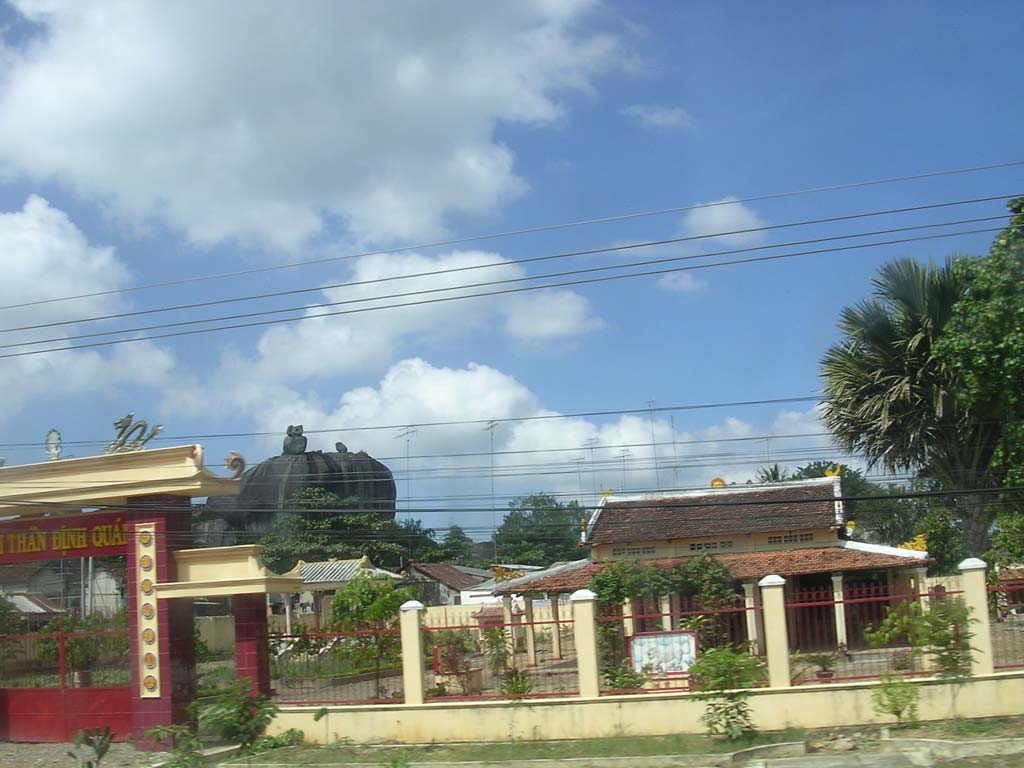 There's a very curious rock formation poking up behind these buildings...