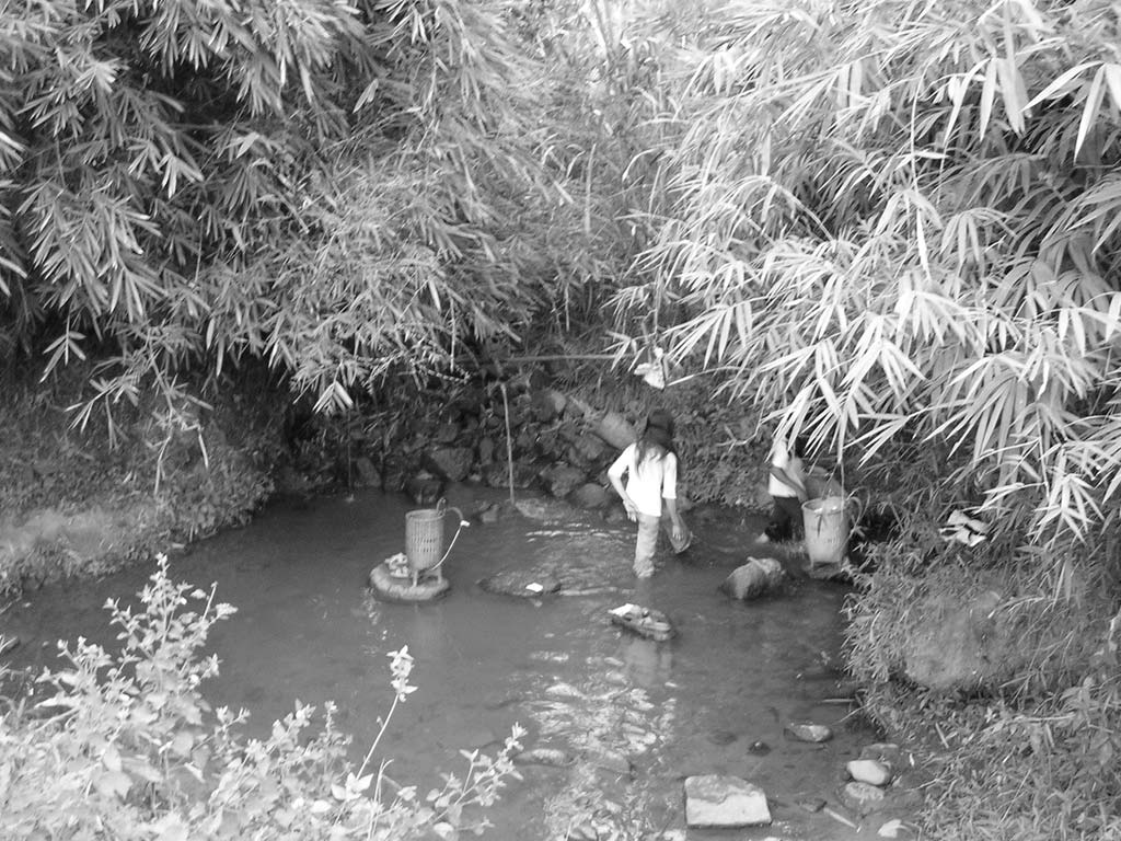 These girls were doing some washing... until they saw the camera