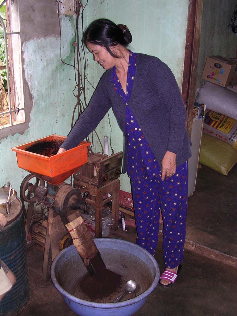 Grinding freshly roasted coffee, some of which we bought