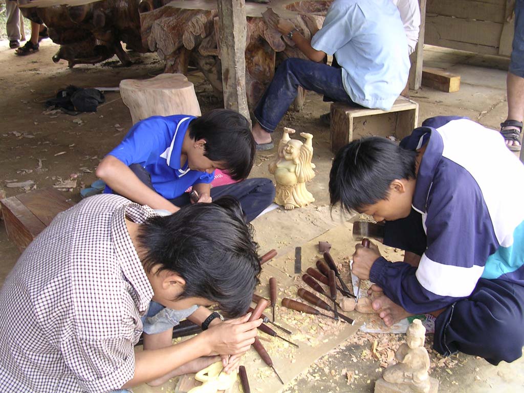 Carving little Buddhas on the floor