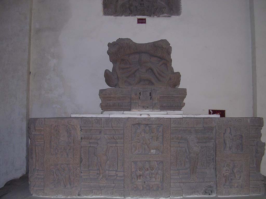 A many-armed god on top of an altar