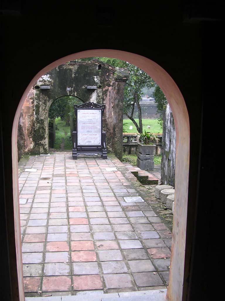 Through the arch at the end, showing one of the beautifully made signs for tourists