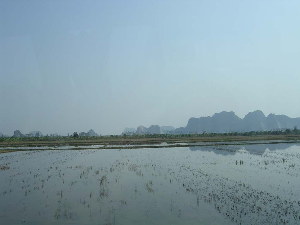 Approaching by bus: the first glimpse of some karsts across the rice paddies