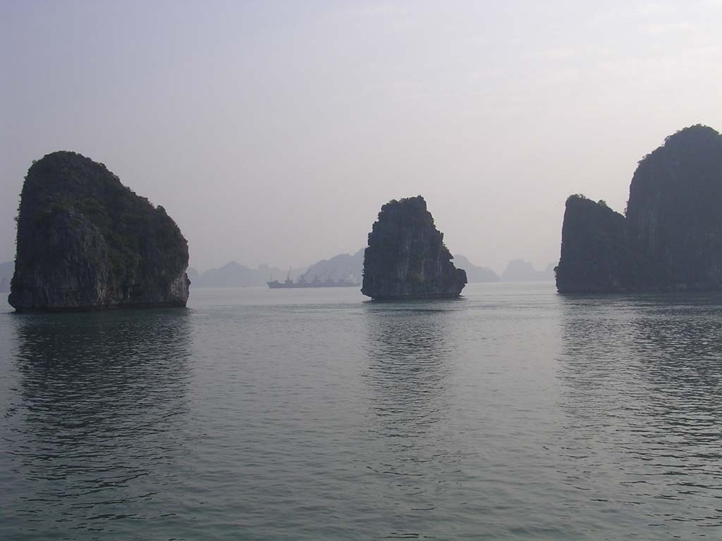 More islands, with a freight vessel in the distance