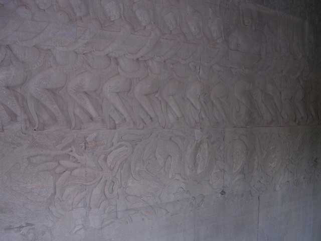 Churning of the Ocean of Milk: <em>deva</em> (gods) holding the tail half of the serpent, with fish below