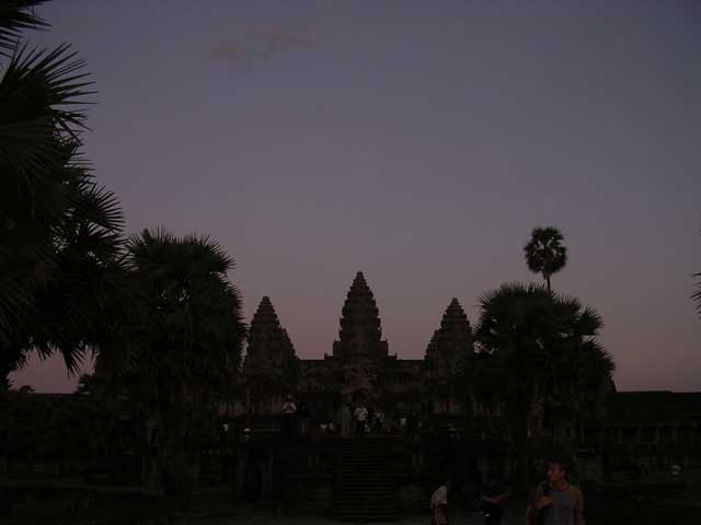 Near-silhouette of the temple with sugar palms (the national tree) at dusk