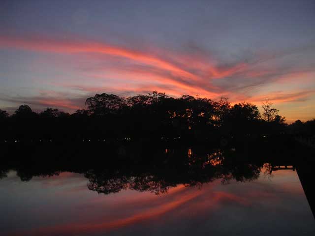 Sunset reflected in the moat of Angkor Wat