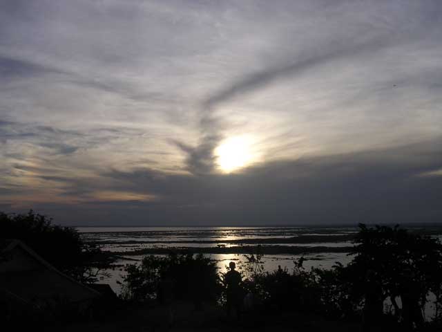 A man looking over Tonlé Sap Lake, Cambodia at sunset