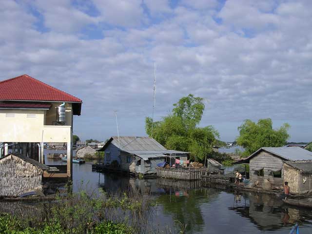 We had to wait while the little boat visible beyond the pillars towed someone's entire home